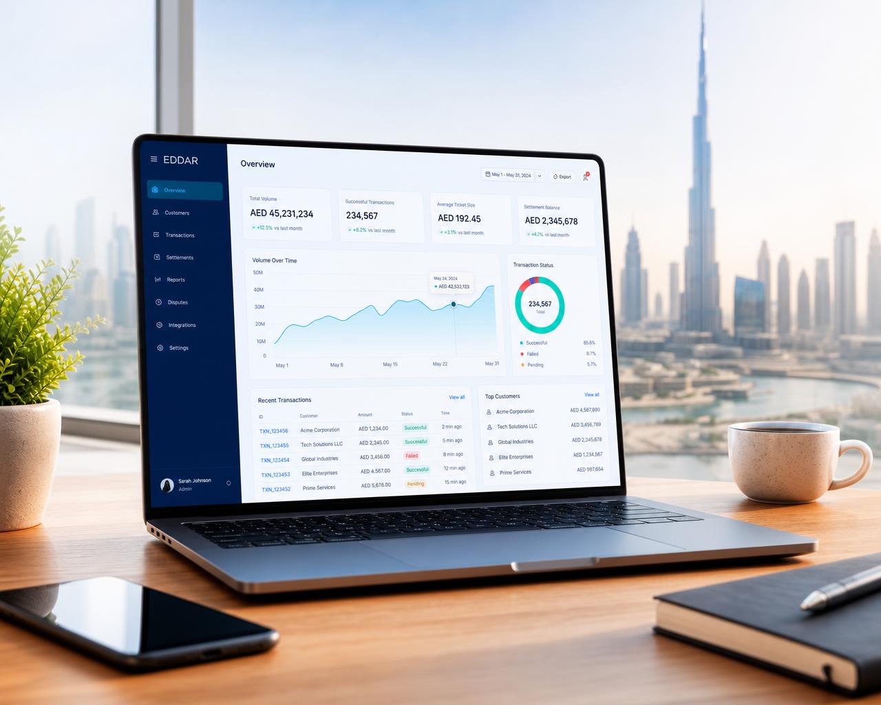 Modern UAE workspace with a laptop showing the Eddar dashboard and the Dubai skyline